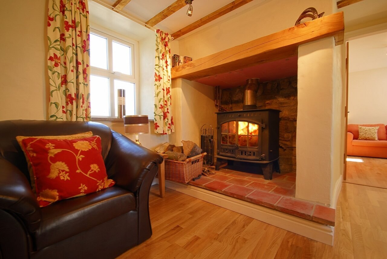 Cosy sitting room with log fire and comfy sofas